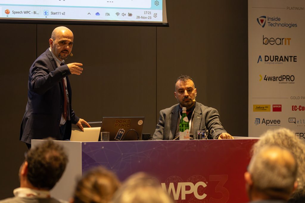 WPC 2023 - Dario Di Toro, Software Foundry Manager e co-founder di BearIT e Marco Blonk-Steiner CTO della business unit Dev Hive di BearIT sul palco per il loro speech "Artificial Proficiency".